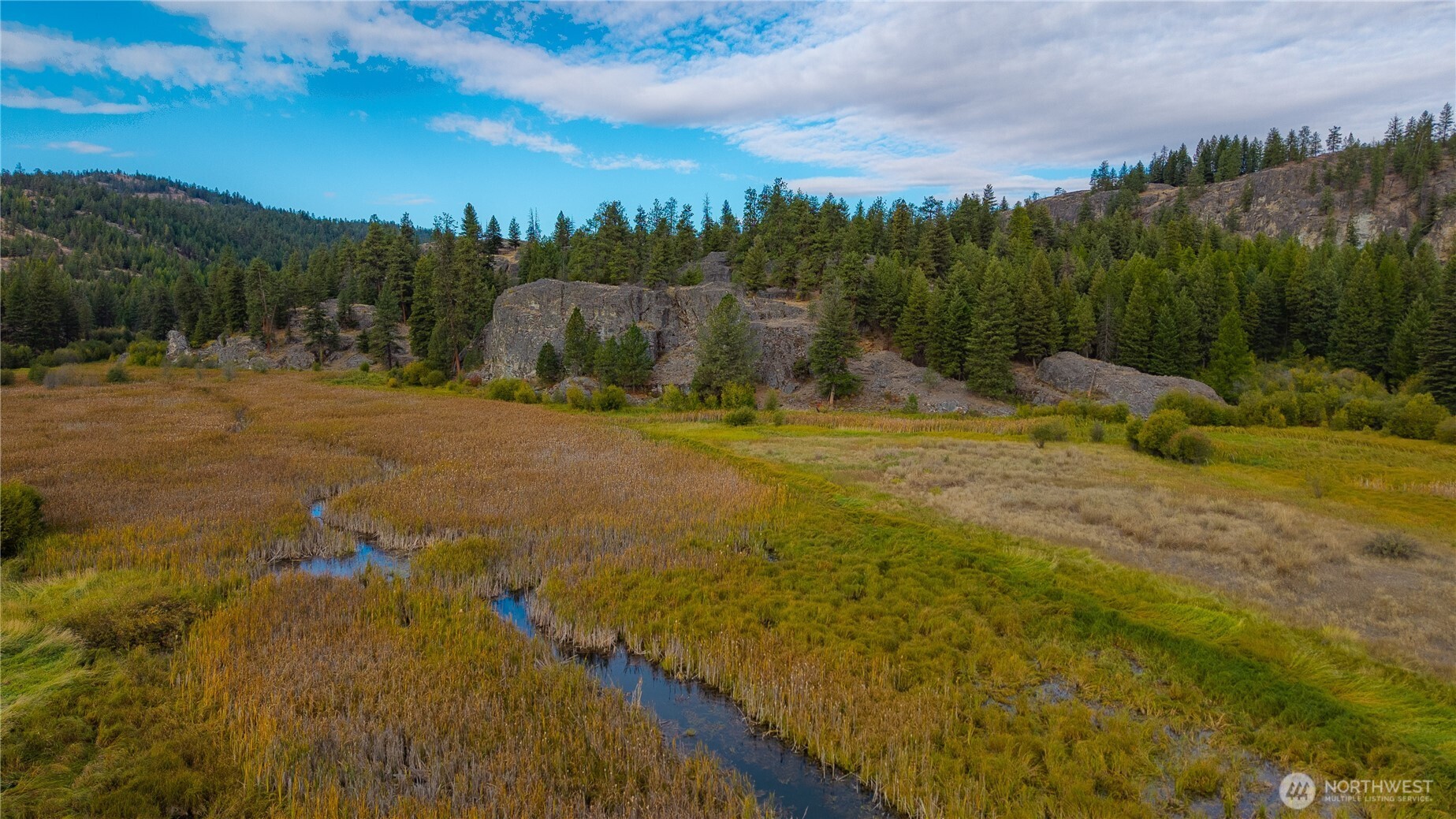 0 Eaglestone Road Tonasket, WA 98855 - Photo 22 of 40 a view of a lake with houses in the back