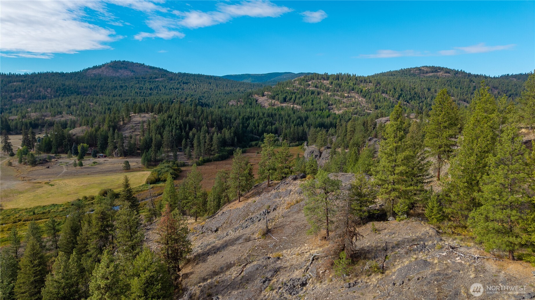0 Eaglestone Road Tonasket, WA 98855 - Photo 10 of 40 a view of a town with mountains in the background