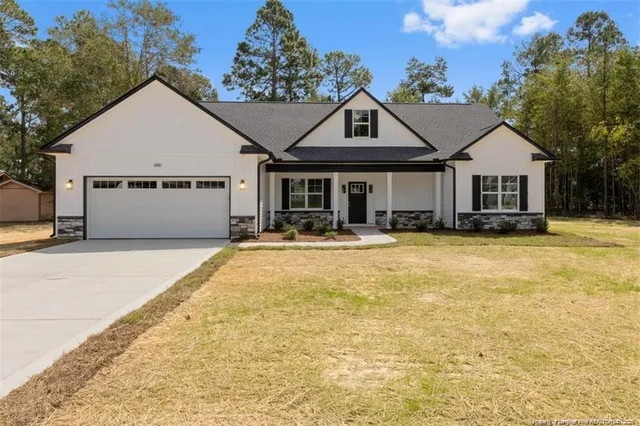 a front view of a house with yard and garage