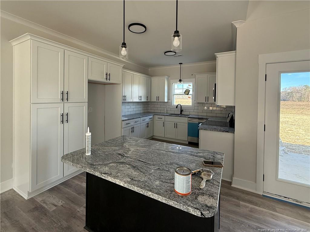 7166 Chicken Foot Road Hope Mills, NC 28348 - Photo 2 of 13 a kitchen with kitchen island granite countertop a sink appliances and cabinets
