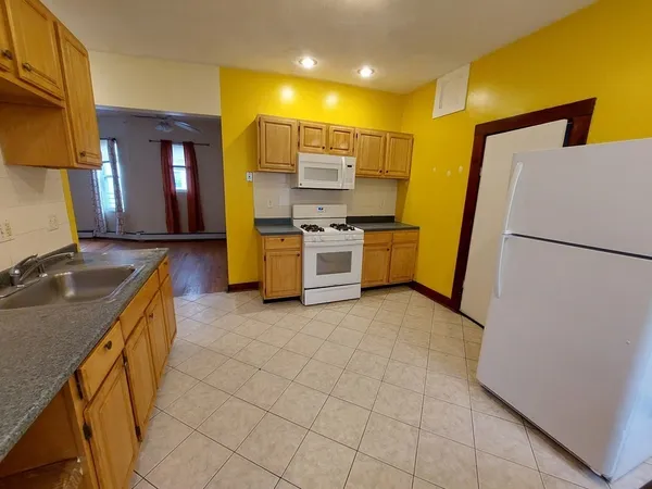 a kitchen with a sink appliances and cabinets