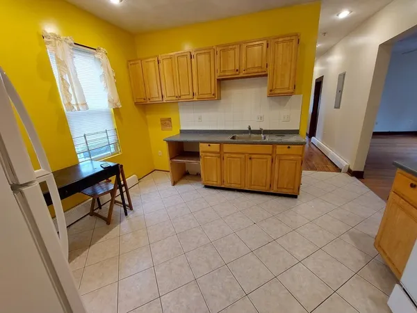 a kitchen with stainless steel appliances a stove a sink and a refrigerator