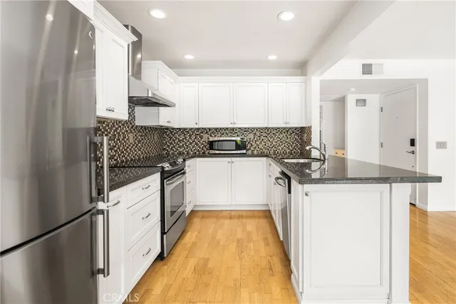 a kitchen with granite countertop a stove and a sink