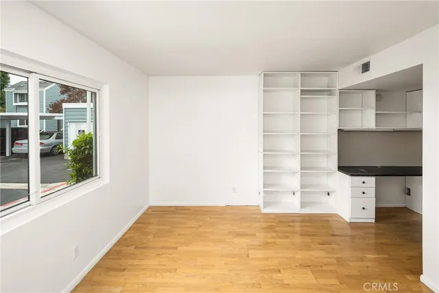 a view of walk in closet with empty racks