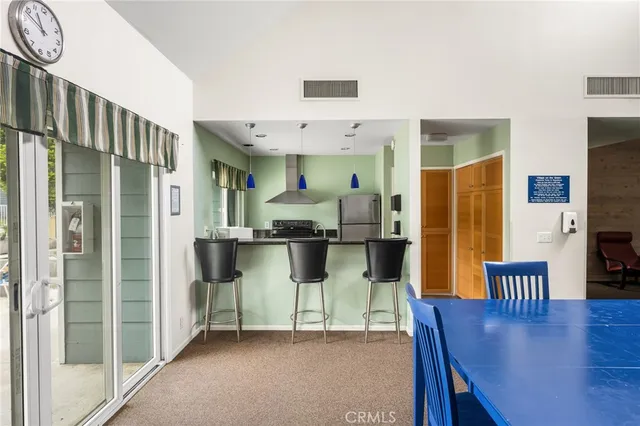 a view of a swimming pool with lawn chairs under an umbrella