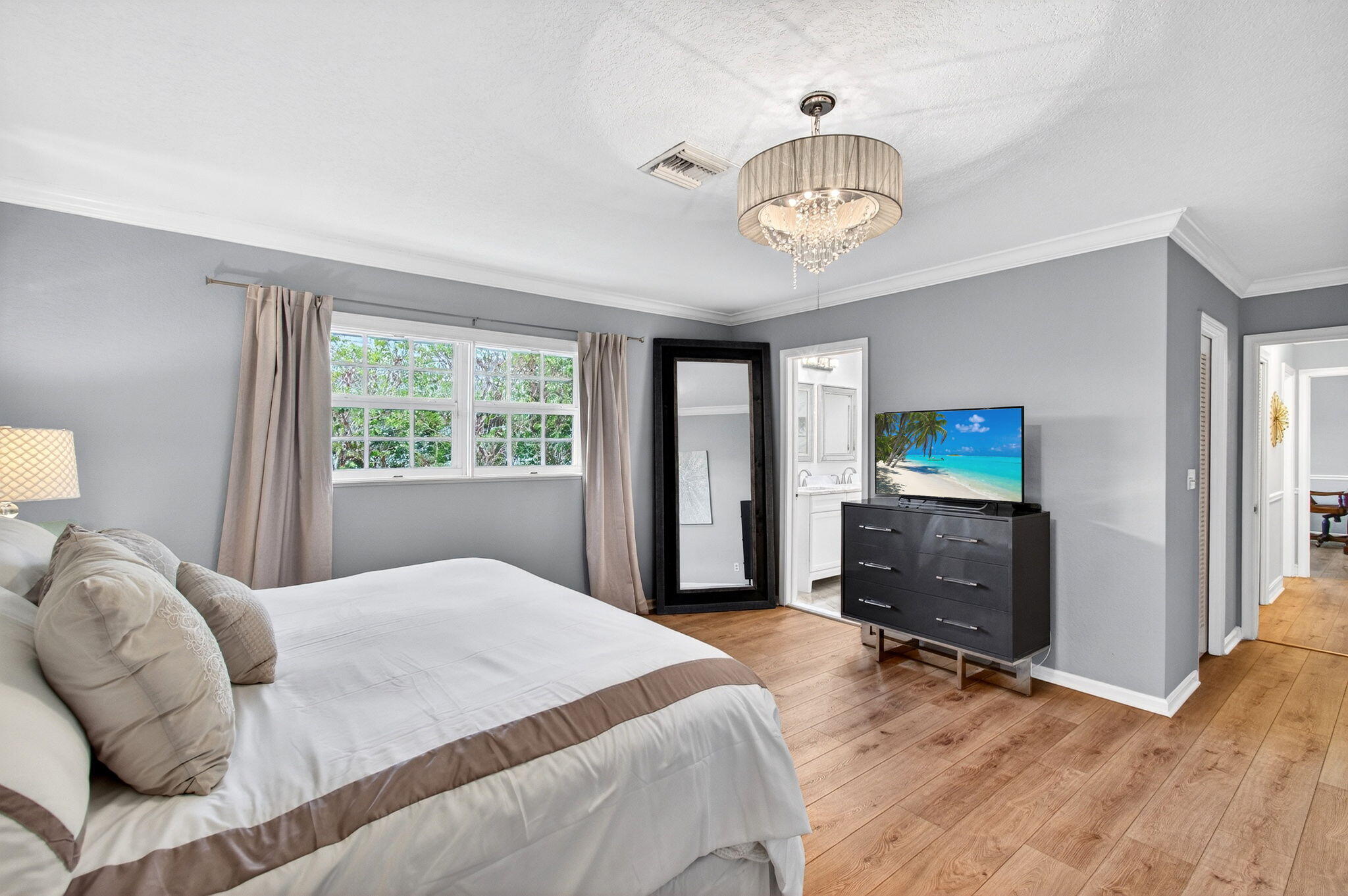 780 Elm Tree Lane Boca Raton, FL 33486 - Photo 54 of 96 a bedroom with a bed and a tv on the dresser
