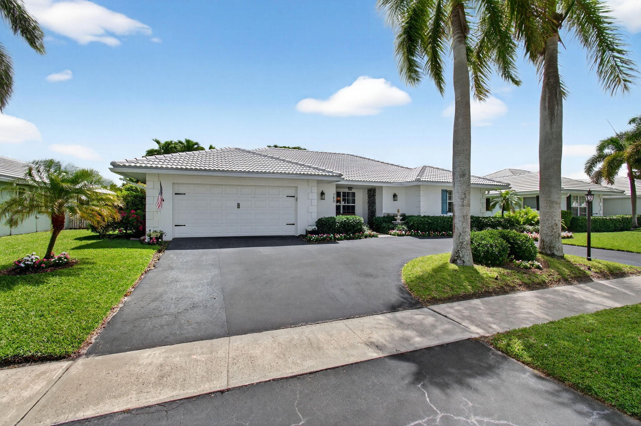 780 Elm Tree Lane Boca Raton, FL 33486 - Photo 7 of 96 a view of a house with a yard and palm trees