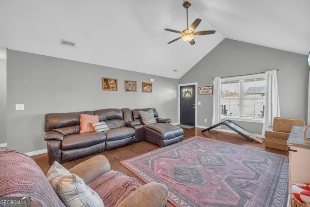 a living room with furniture chandelier and window