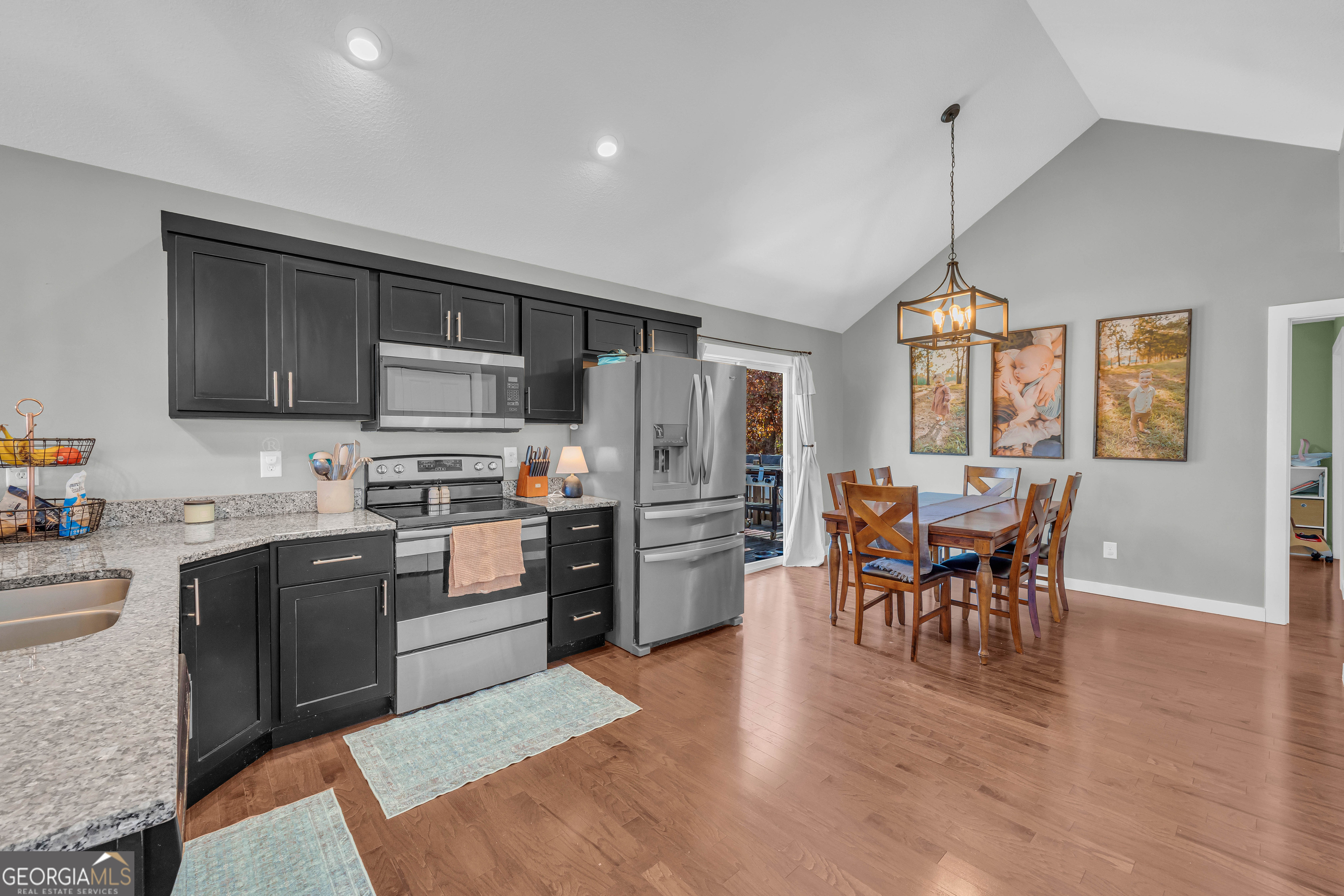 323 North Point Circle Hartwell, GA 30643 - Photo 13 of 42 a kitchen with stainless steel appliances granite countertop a stove top oven a sink dishwasher a dining table and chairs with wooden floor