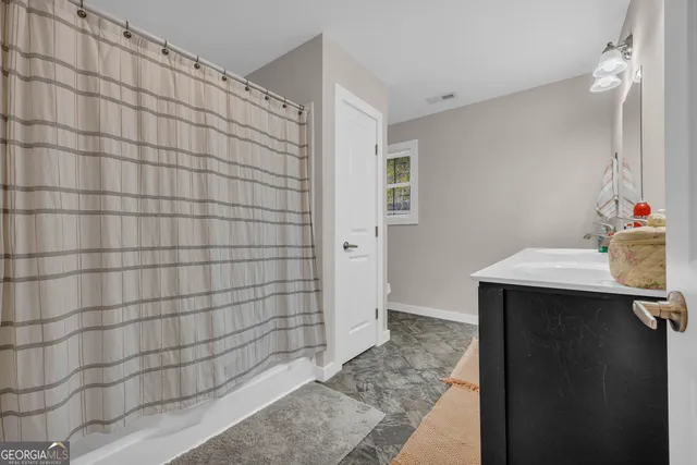 a bathroom with a sink vanity and a mirror
