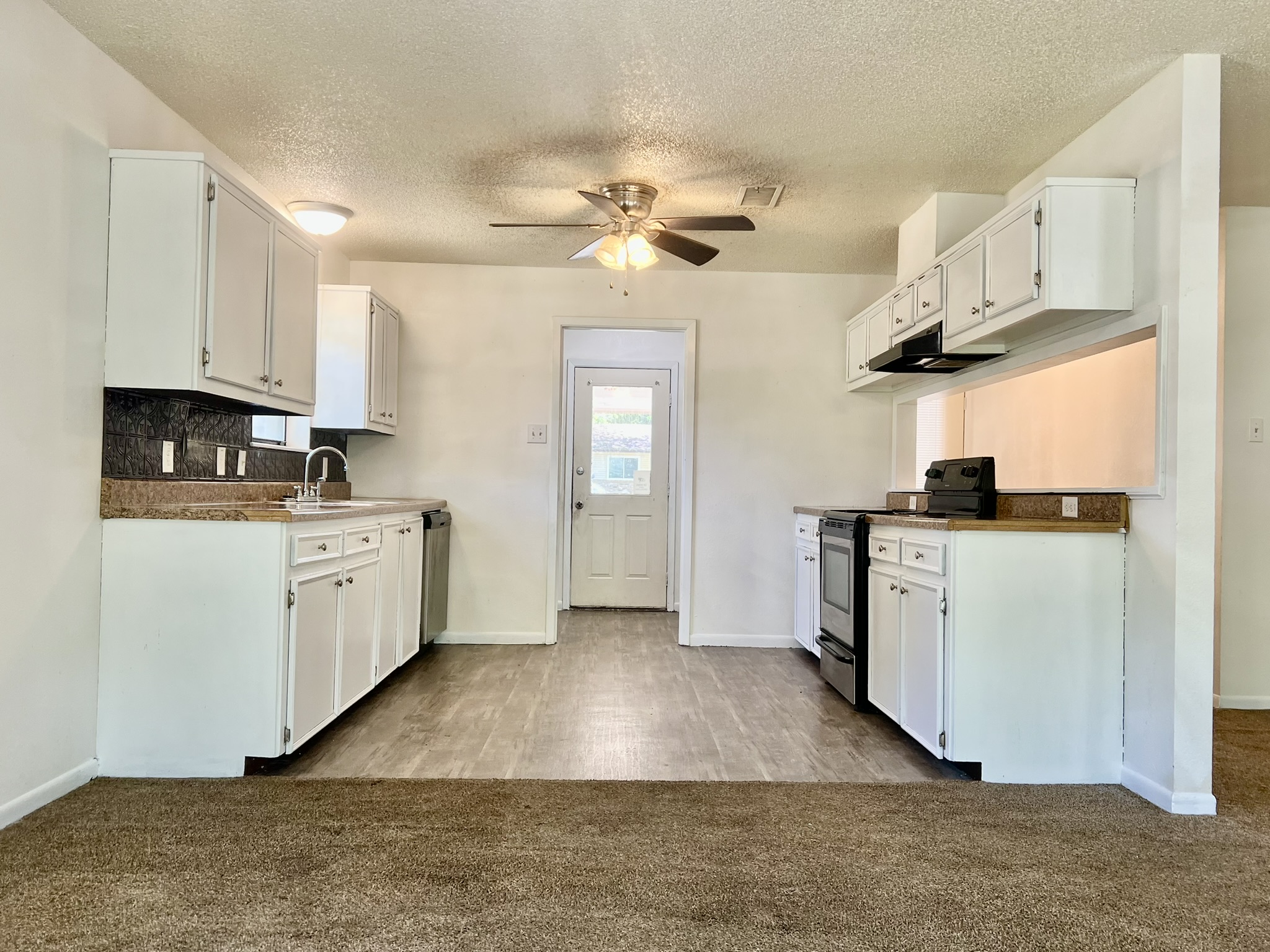 302 Harris Street Smithville, TX 78957 - Photo 2 of 7 a kitchen with cabinets and window