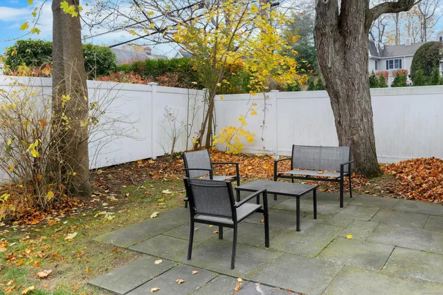 a view of a chairs and table in backyard