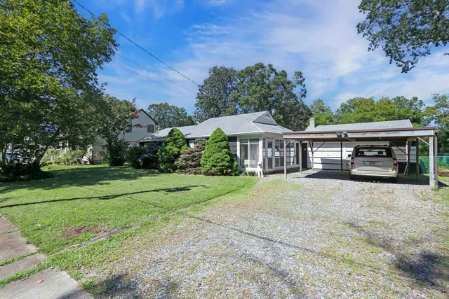 a front view of a house with garden and porch