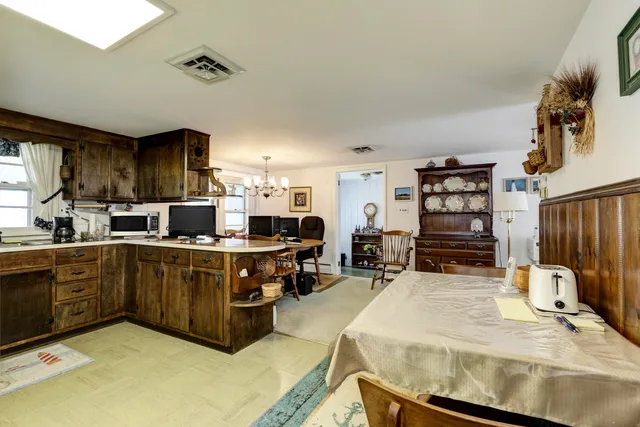 a kitchen with stainless steel appliances kitchen island granite countertop a refrigerator and cabinets