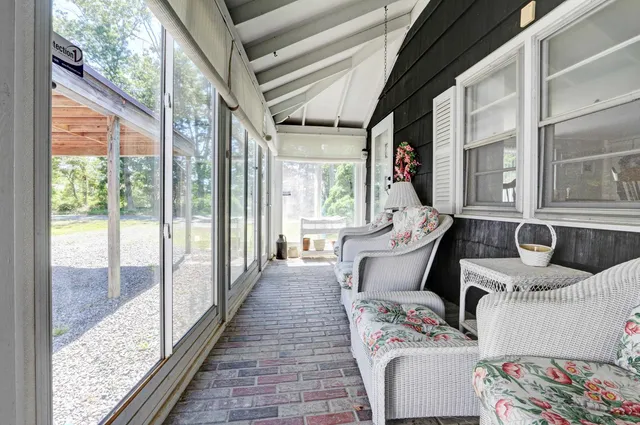 a balcony with furniture and a potted plant