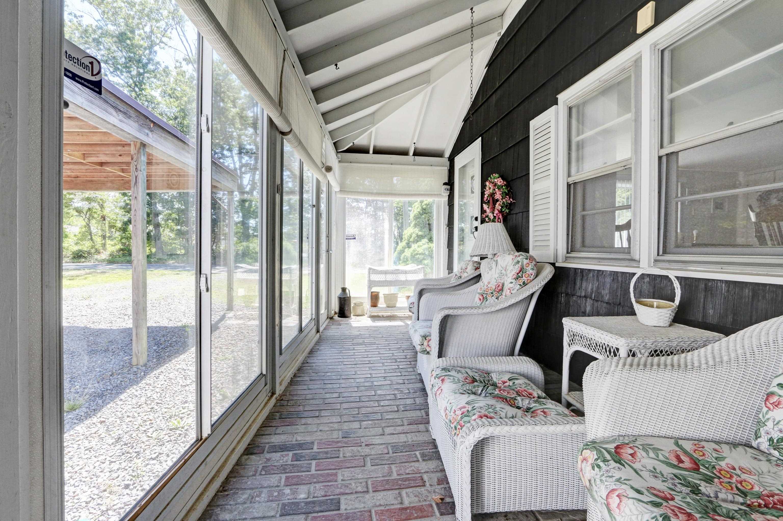 12 West Cedar Avenue Rio Grande, NJ 08242 - Photo 2 of 40 a balcony with furniture and a potted plant