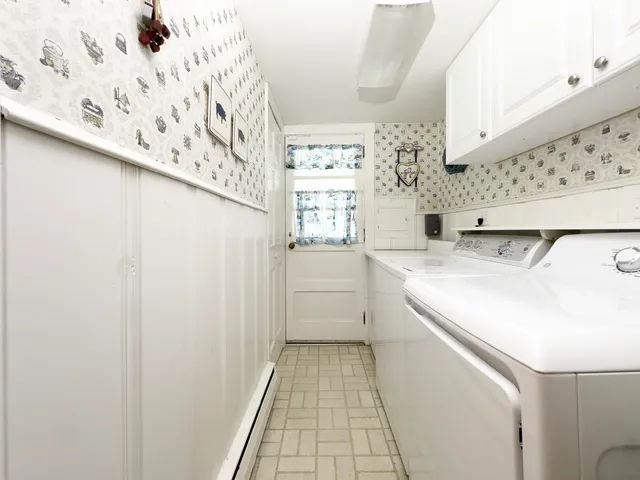 a utility room with cabinets washer and dryer
