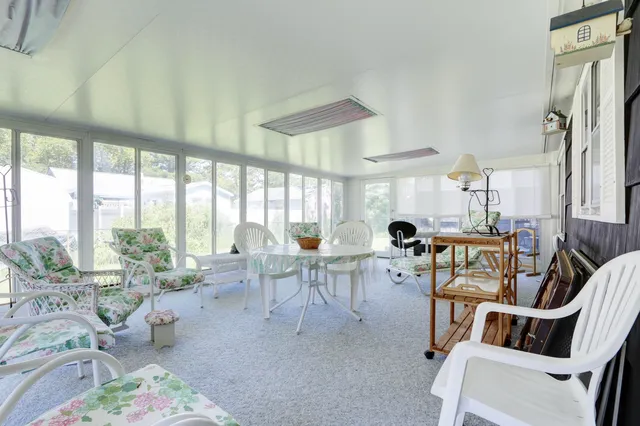 a living room with furniture a large window and a table