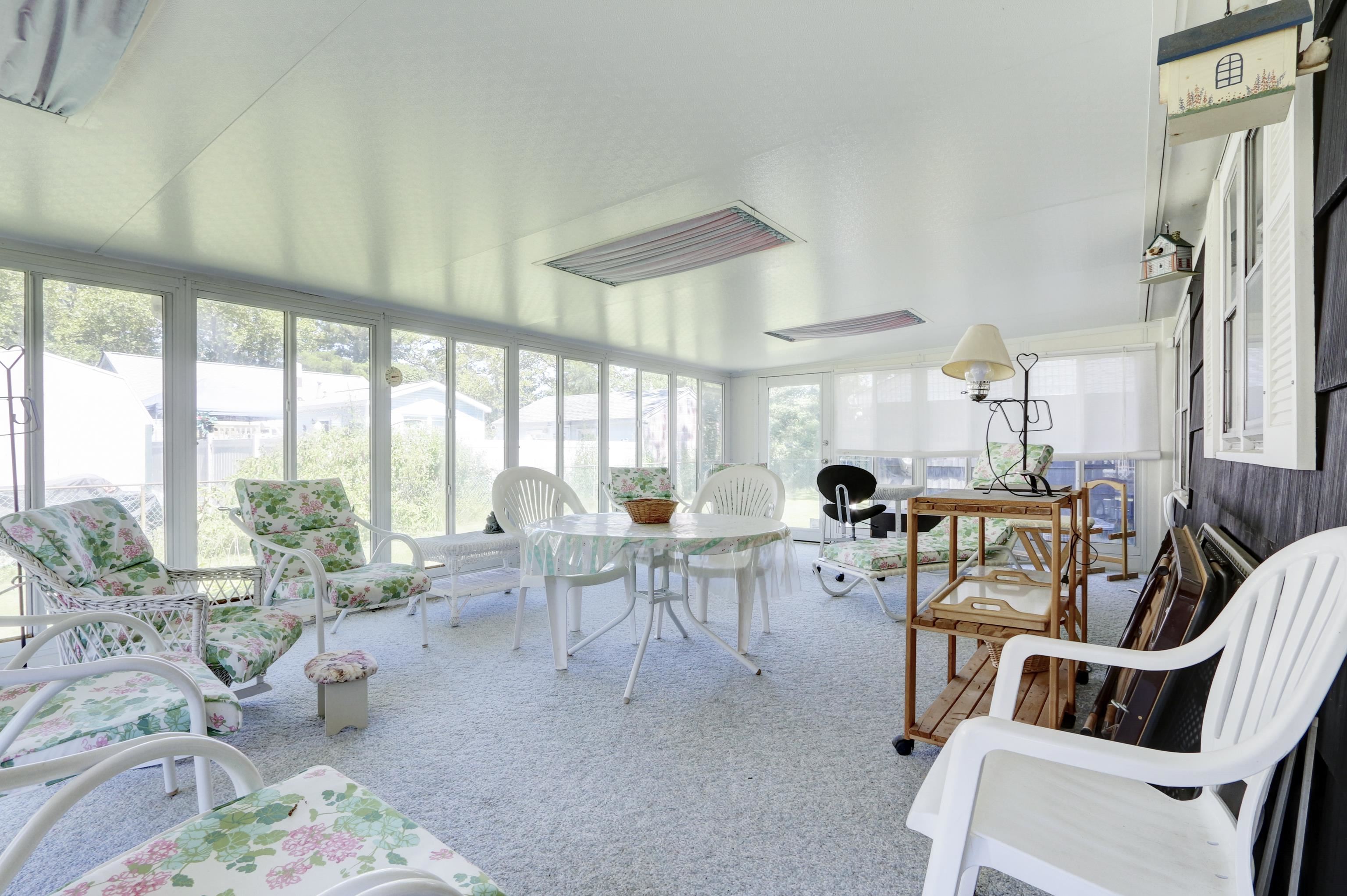 12 West Cedar Avenue Rio Grande, NJ 08242 - Photo 29 of 40 a living room with furniture a large window and a table