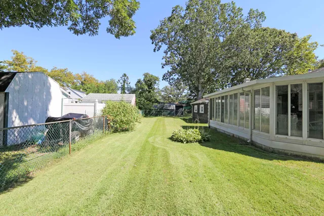 a view of backyard with a small cabin