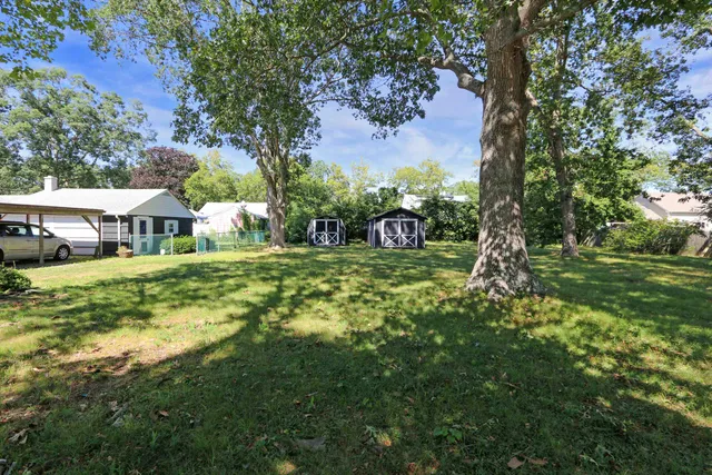 a view of an house with backyard space and sitting area