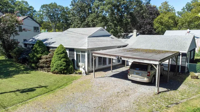 a view of a house with backyard and sitting area