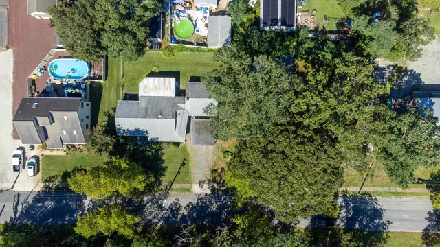 an aerial view of a house with a yard and garden