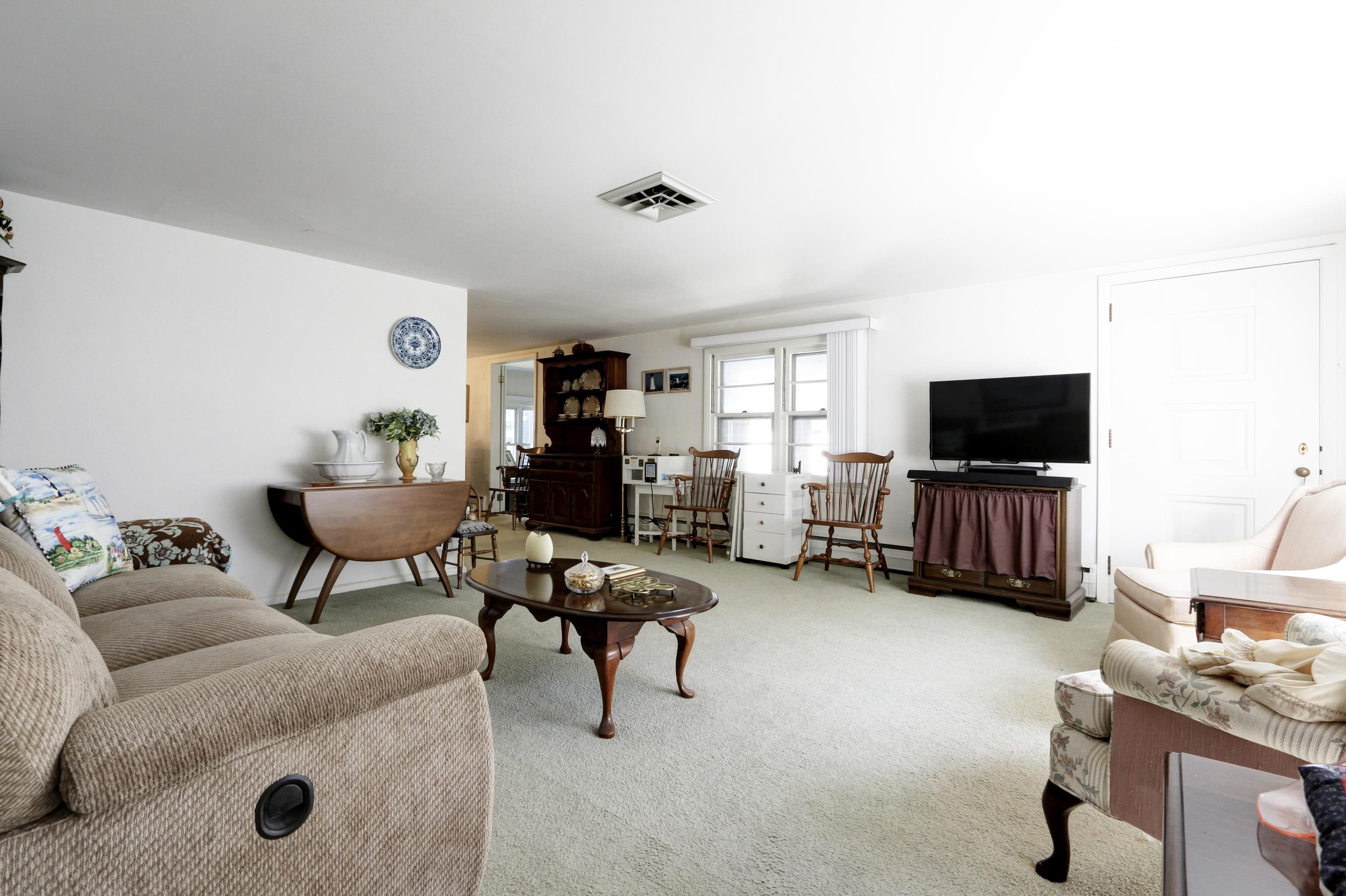 12 West Cedar Avenue Rio Grande, NJ 08242 - Photo 6 of 40 a living room with furniture and a flat screen tv