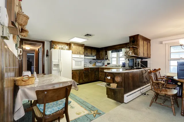a living room with stainless steel appliances kitchen island granite countertop furniture and a kitchen view