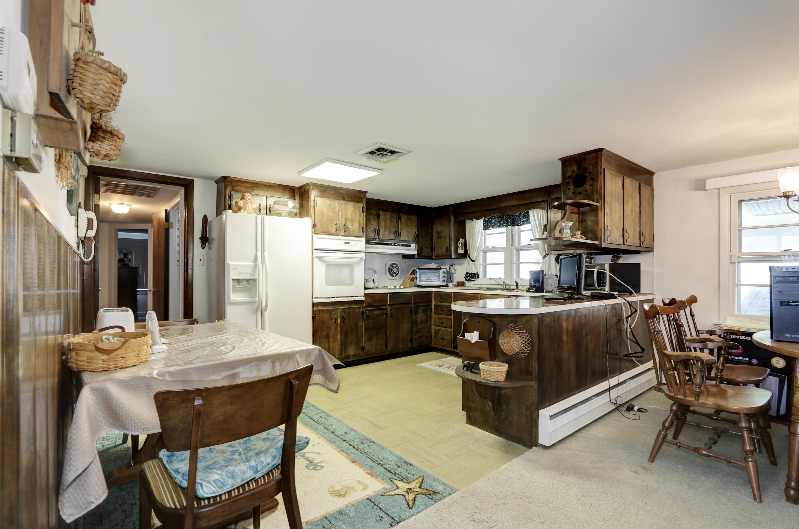 12 West Cedar Avenue Rio Grande, NJ 08242 - Photo 9 of 40 a living room with stainless steel appliances kitchen island granite countertop furniture and a kitchen view
