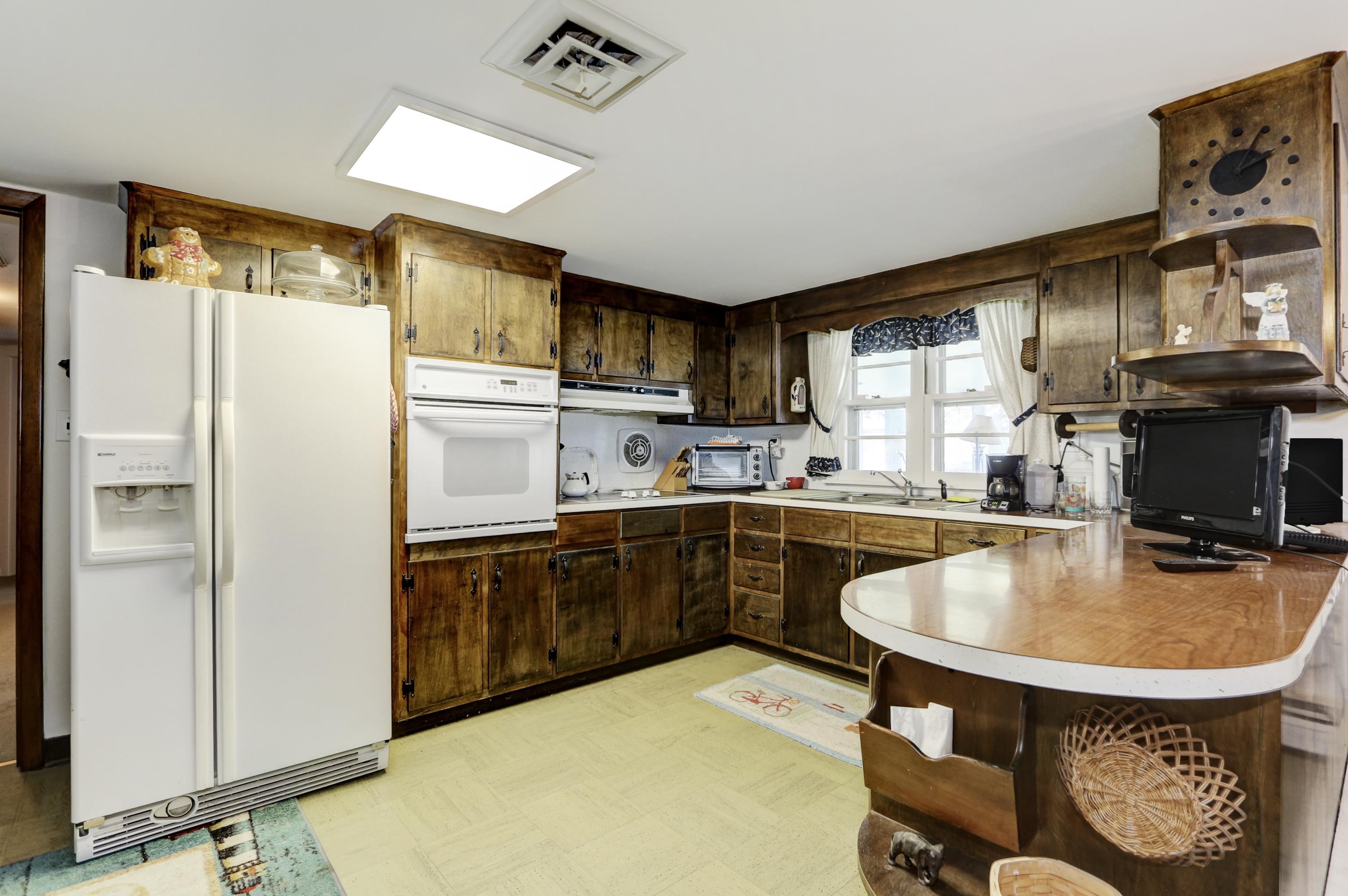 12 West Cedar Avenue Rio Grande, NJ 08242 - Photo 10 of 40 a kitchen with kitchen island a sink appliances and cabinets