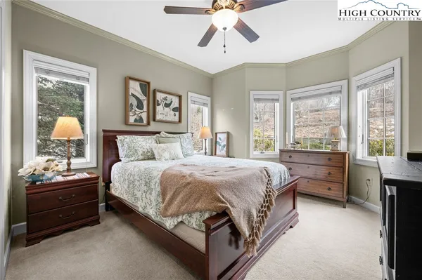 a bedroom with a bed and large window