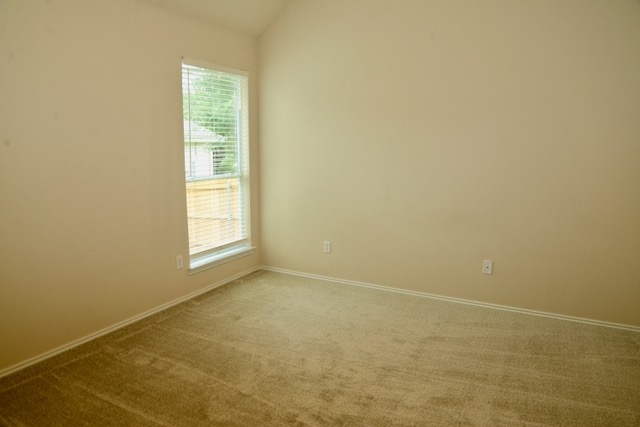 138 Chestnut Court Georgetown, TX 78633 - Photo 23 of 25 A well-lit, quiet bedroom with plush carpet and a large window providing ample natural light.