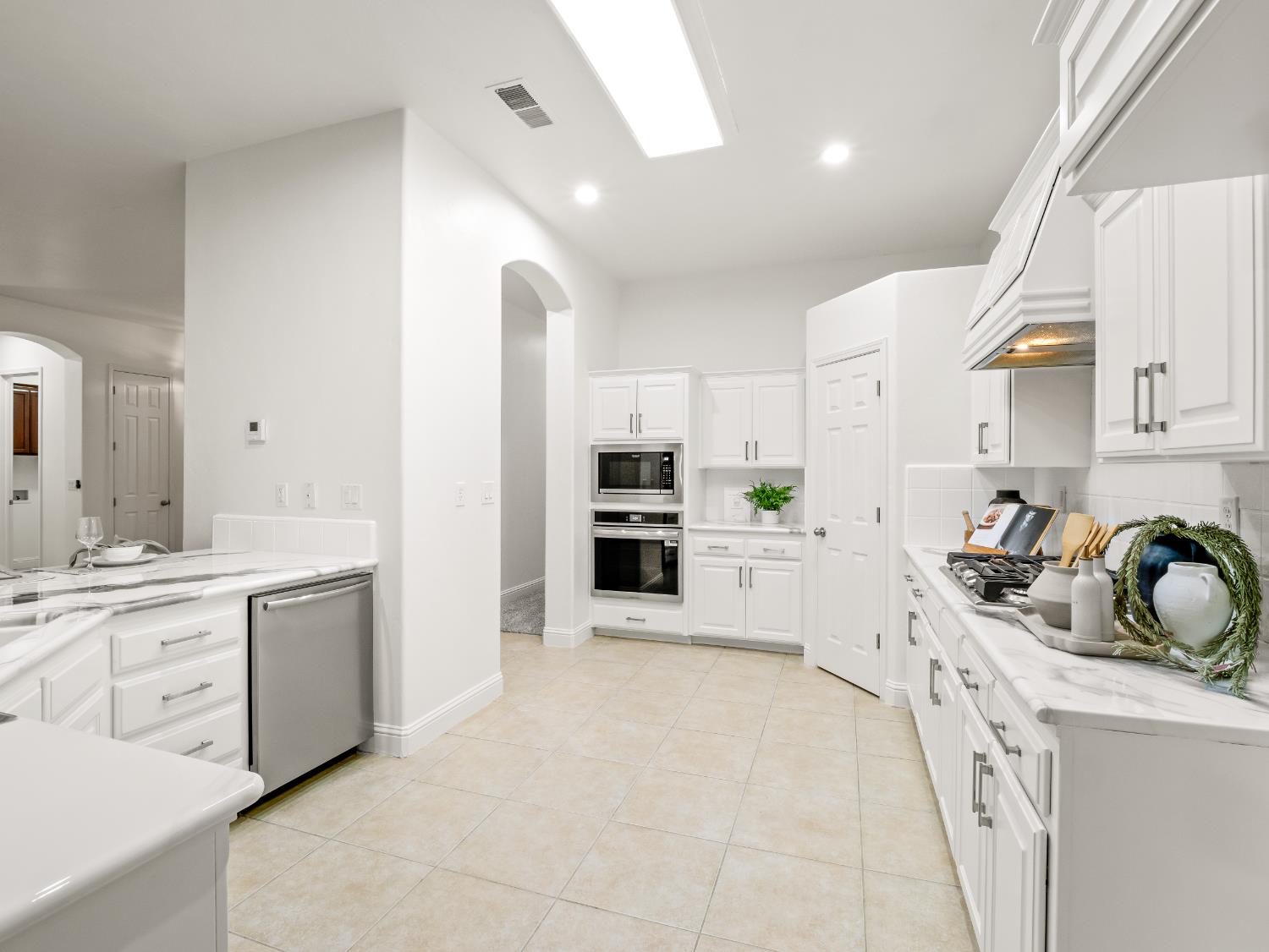 8683 North Richelle Avenue Fresno, CA 93720 - Photo 13 of 44 a kitchen with a sink stove and cabinets