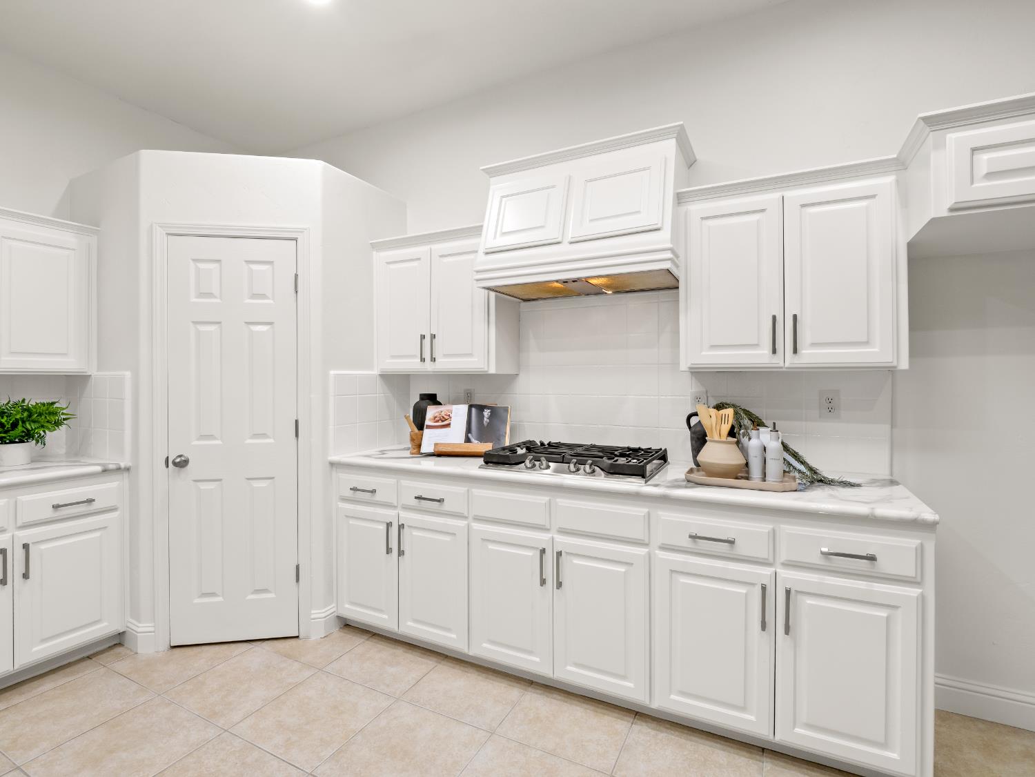 8683 North Richelle Avenue Fresno, CA 93720 - Photo 14 of 44 a kitchen with white cabinets and sink
