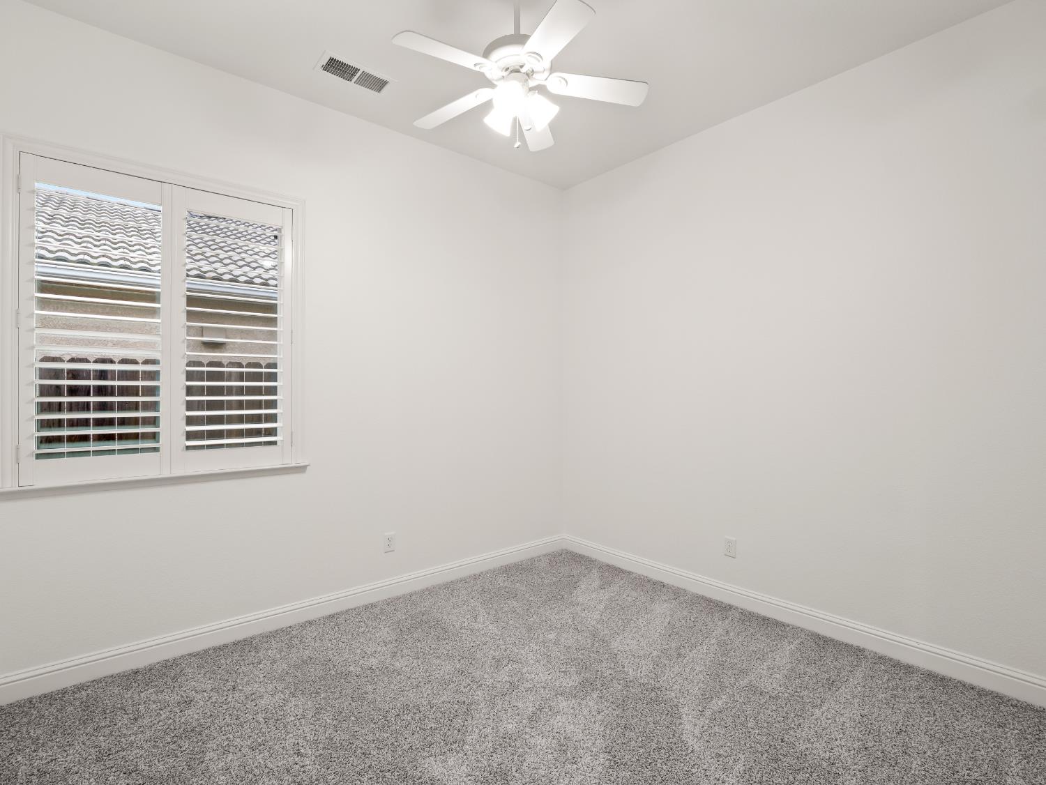 8683 North Richelle Avenue Fresno, CA 93720 - Photo 18 of 44 an empty room with a window and a fan