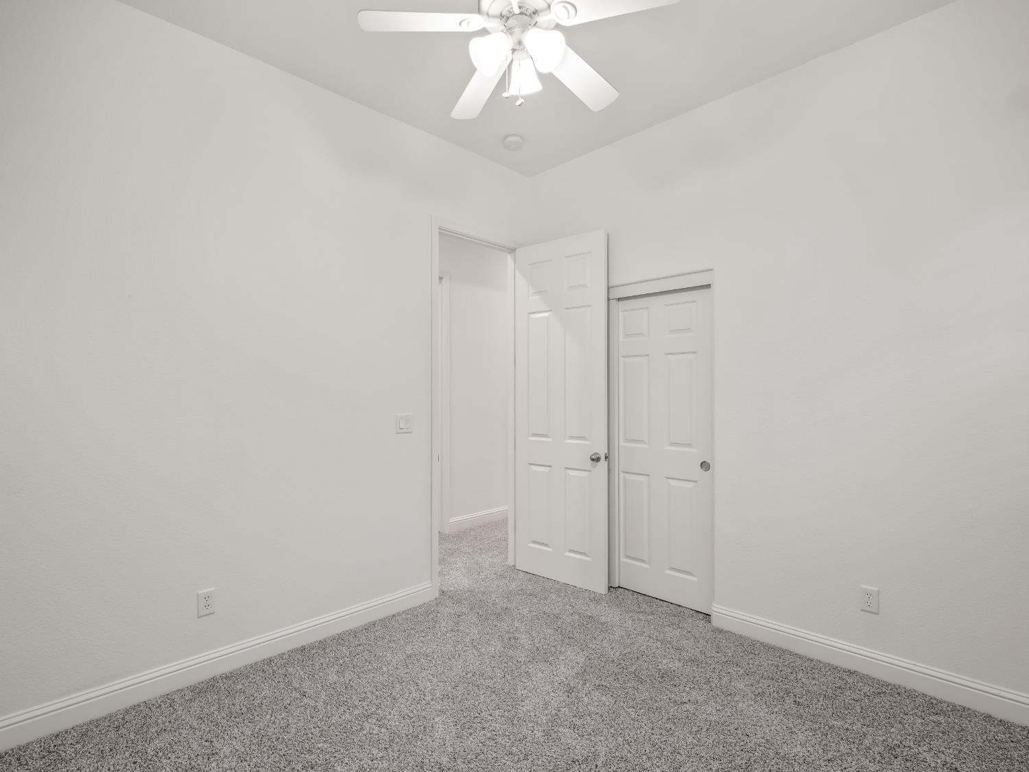 8683 North Richelle Avenue Fresno, CA 93720 - Photo 19 of 44 an empty room with a ceiling fan and window