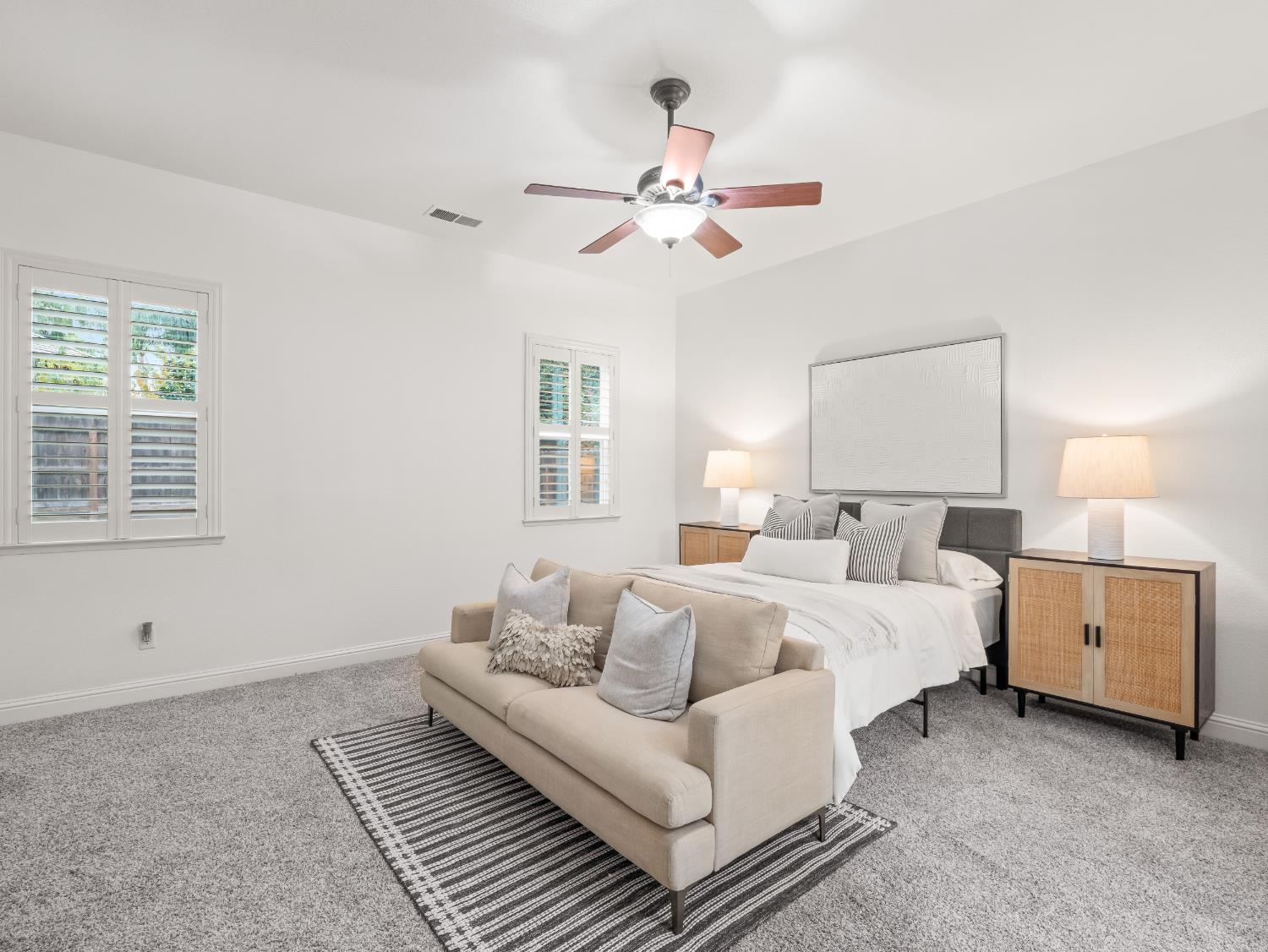 8683 North Richelle Avenue Fresno, CA 93720 - Photo 29 of 44 a spacious bedroom with a bed and a couch