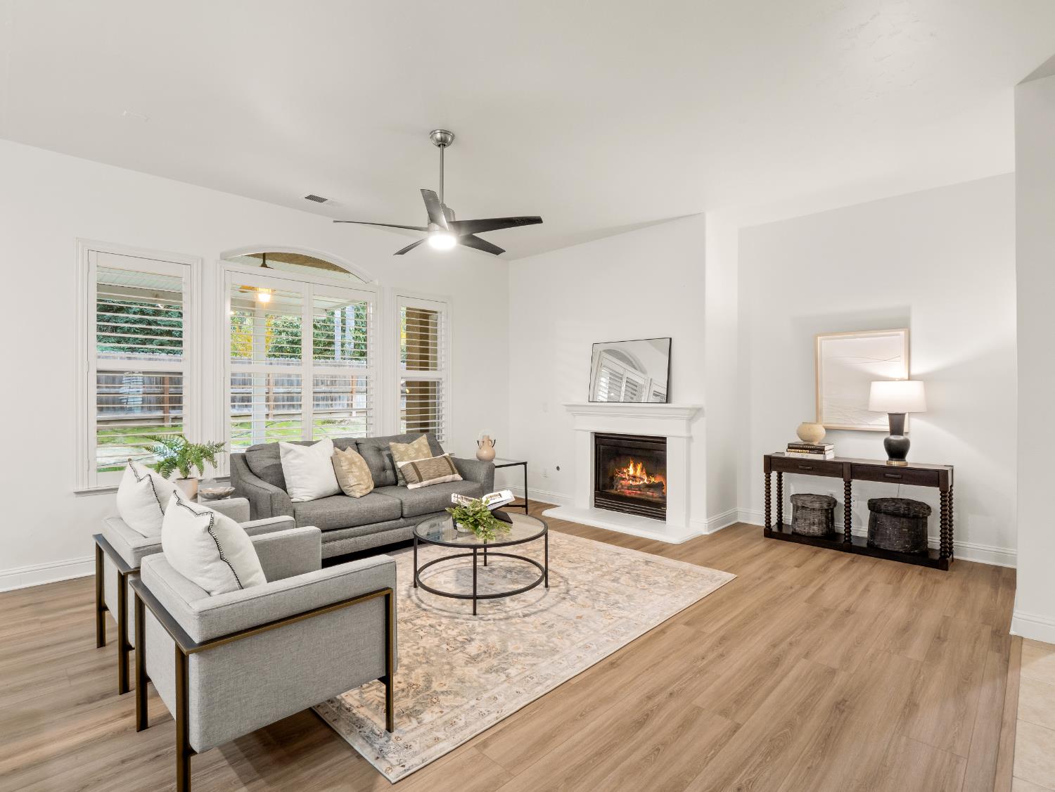 8683 North Richelle Avenue Fresno, CA 93720 - Photo 4 of 44 a living room with furniture a fireplace and a flat screen tv
