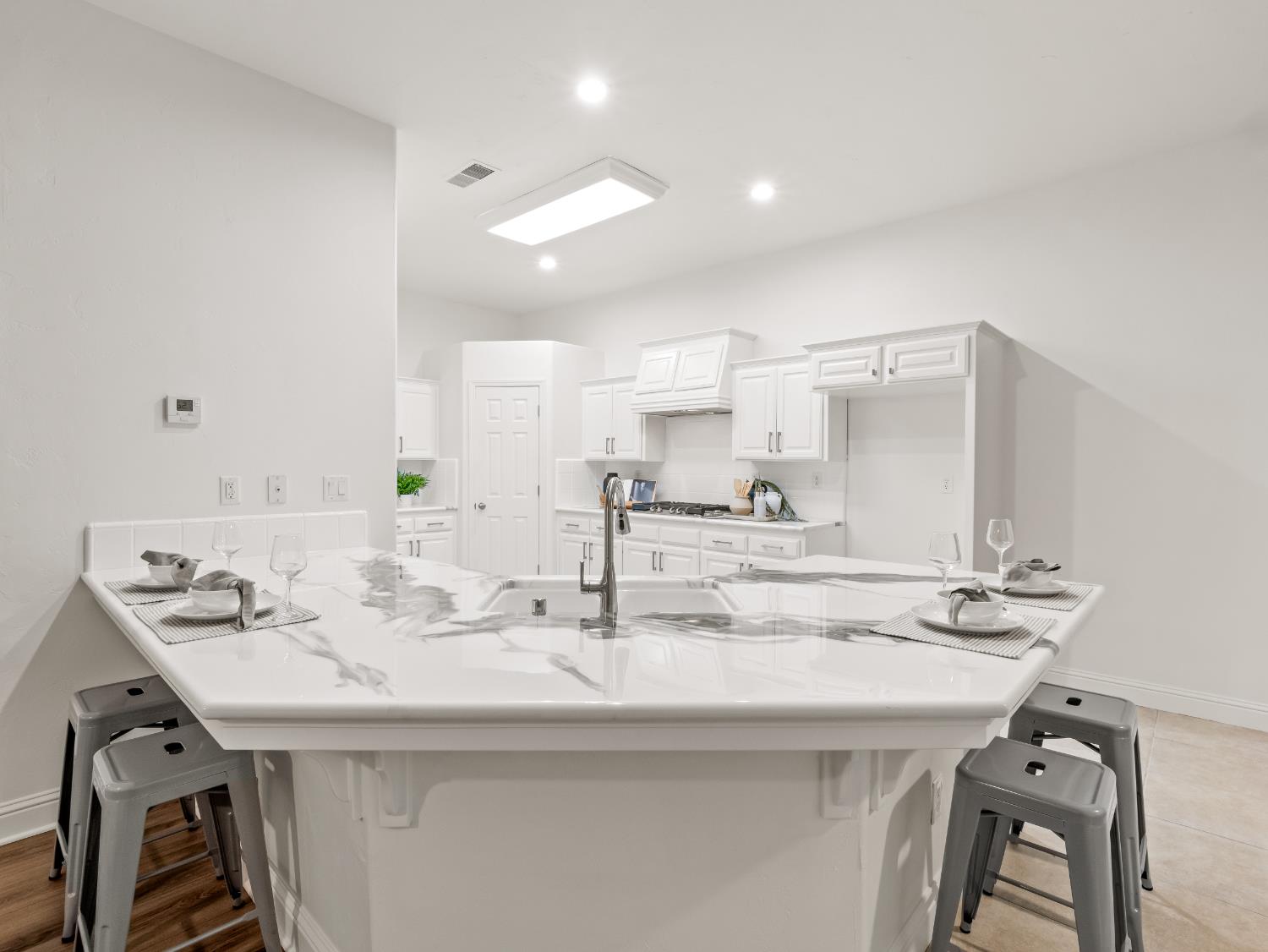 8683 North Richelle Avenue Fresno, CA 93720 - Photo 9 of 44 a kitchen with kitchen island a sink and appliances