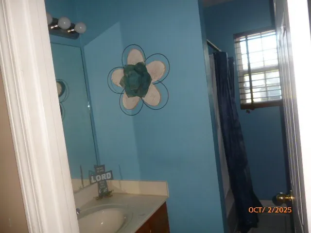 a bathroom with a sink and mirror