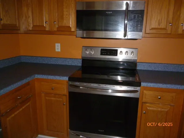 a stove top oven sitting inside of a kitchen