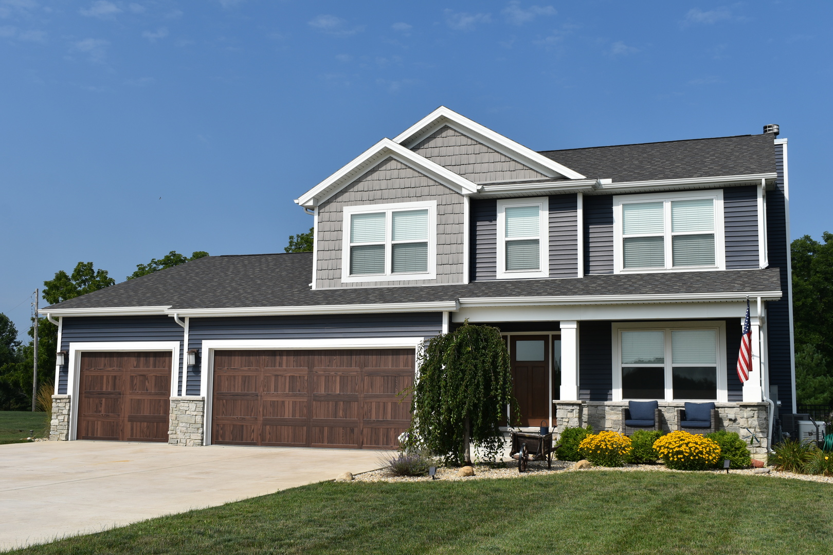 a front view of a house with a yard and garage
