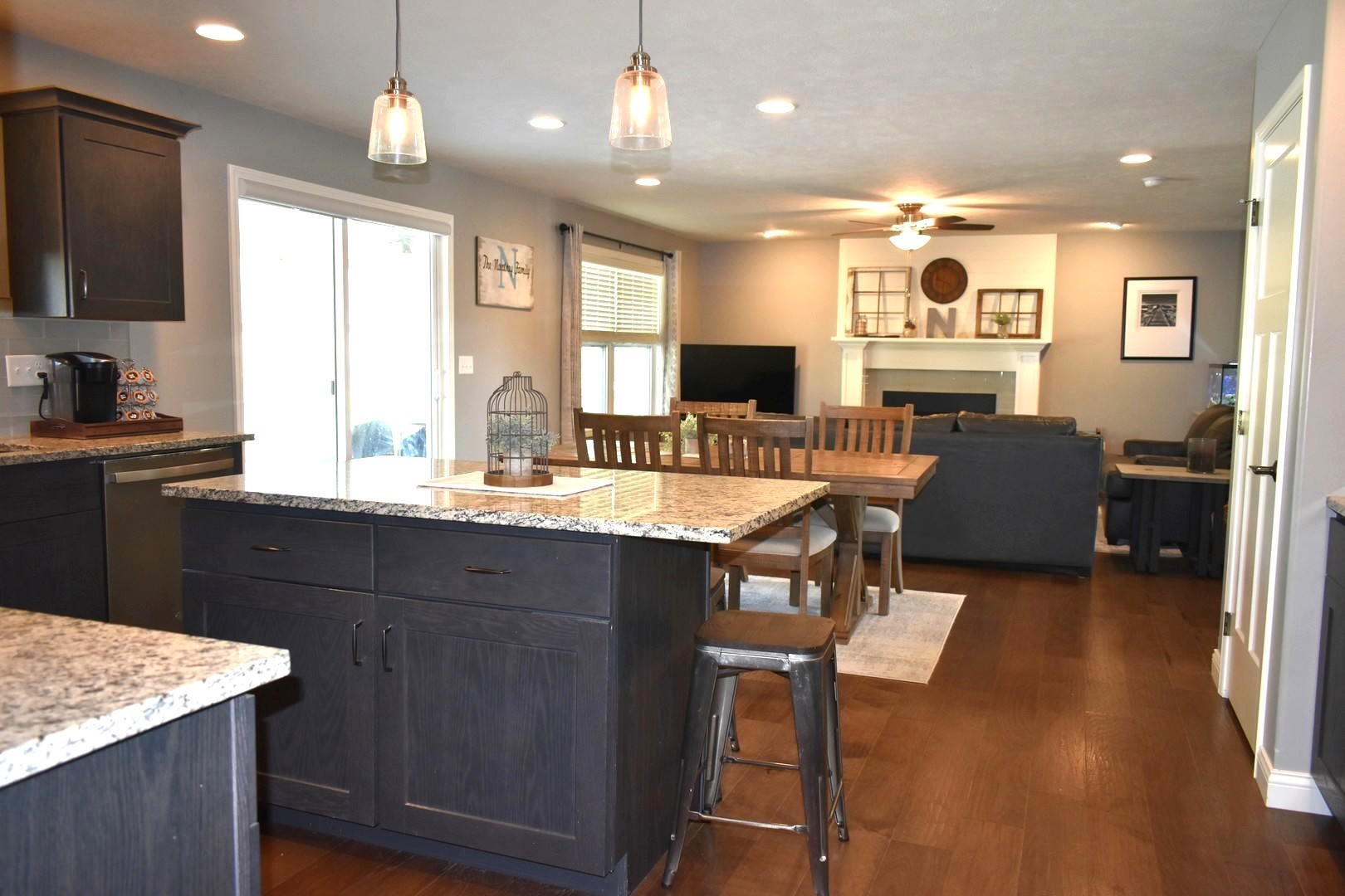 13 Wolf Run Road El Paso, IL 61738 - Photo 20 of 57 a open kitchen with stainless steel appliances granite countertop a refrigerator a sink dishwasher a dining table and chairs with wooden floor