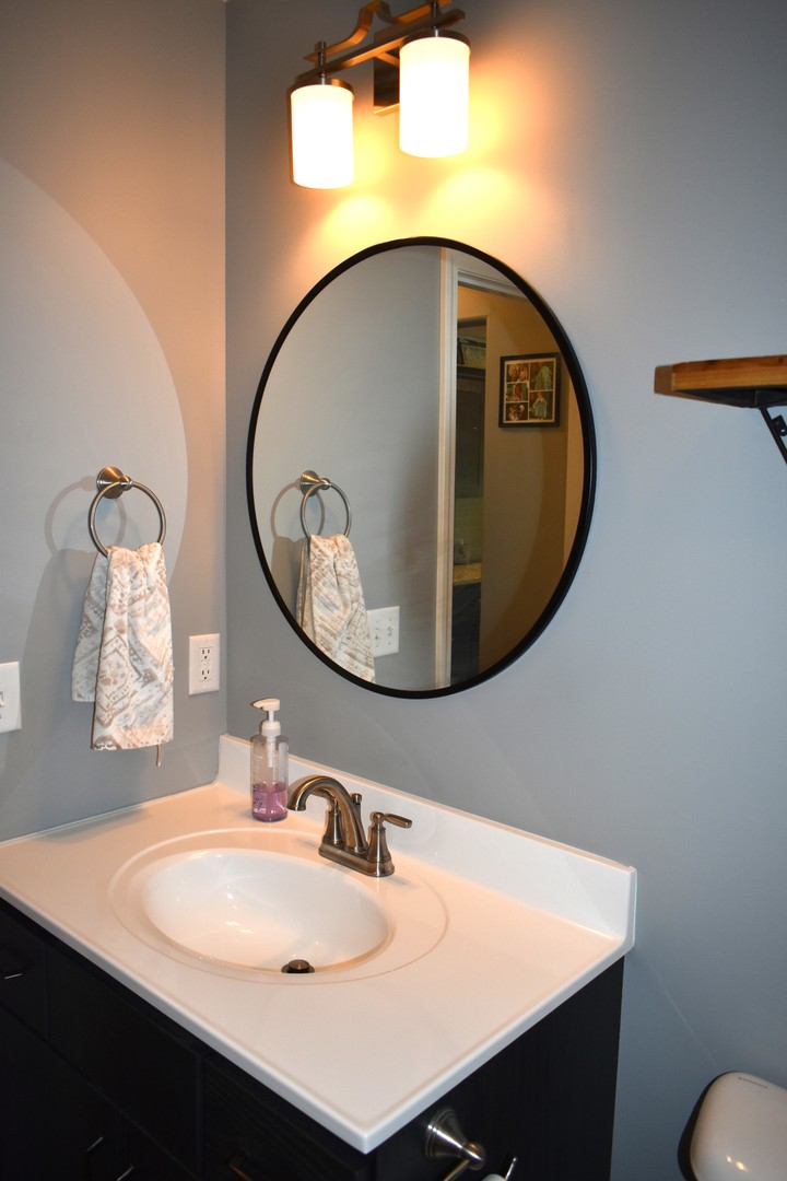 13 Wolf Run Road El Paso, IL 61738 - Photo 29 of 57 a bathroom with a sink mirror and vanity