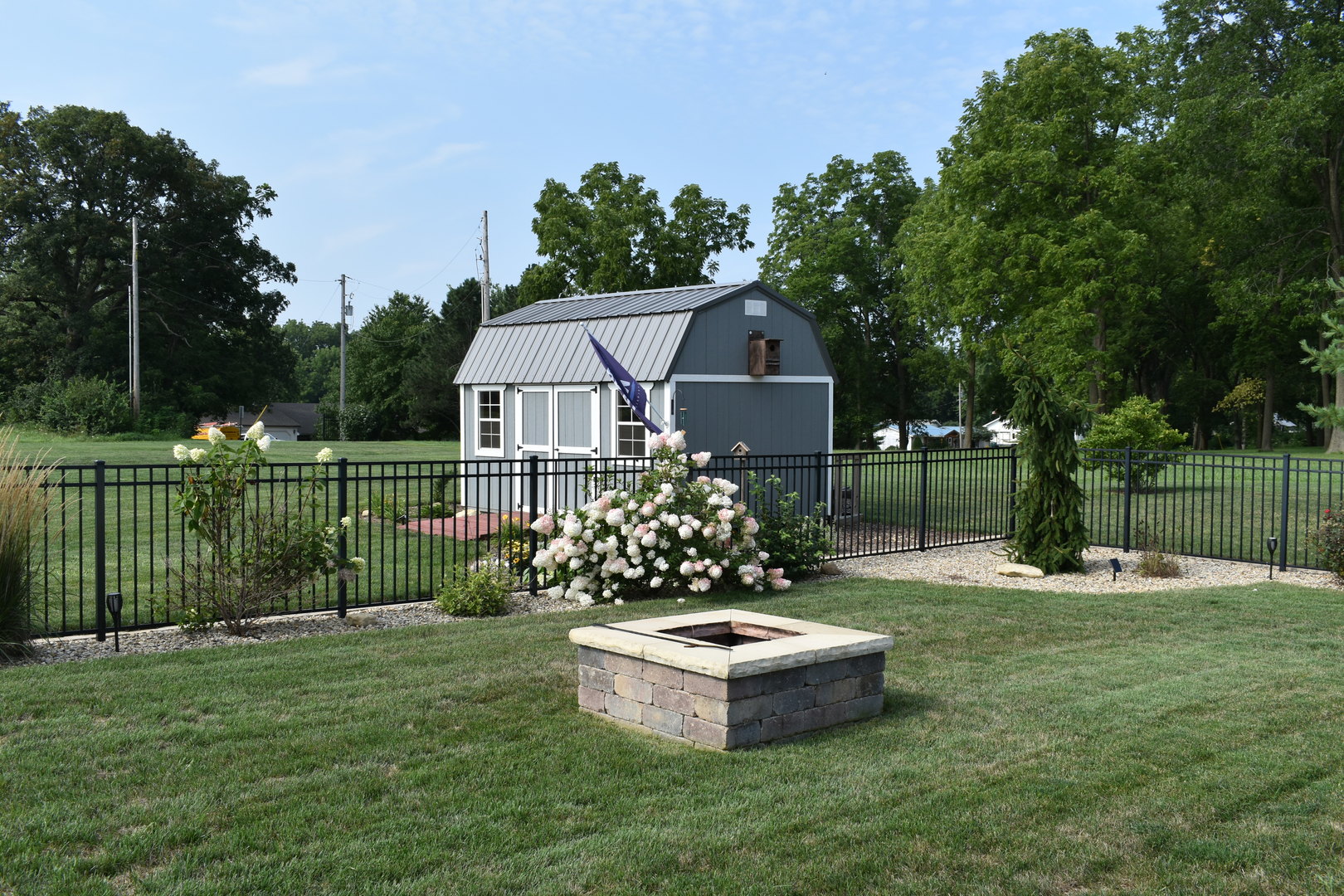 13 Wolf Run Road El Paso, IL 61738 - Photo 7 of 57 a front view of a house with a garden and trees