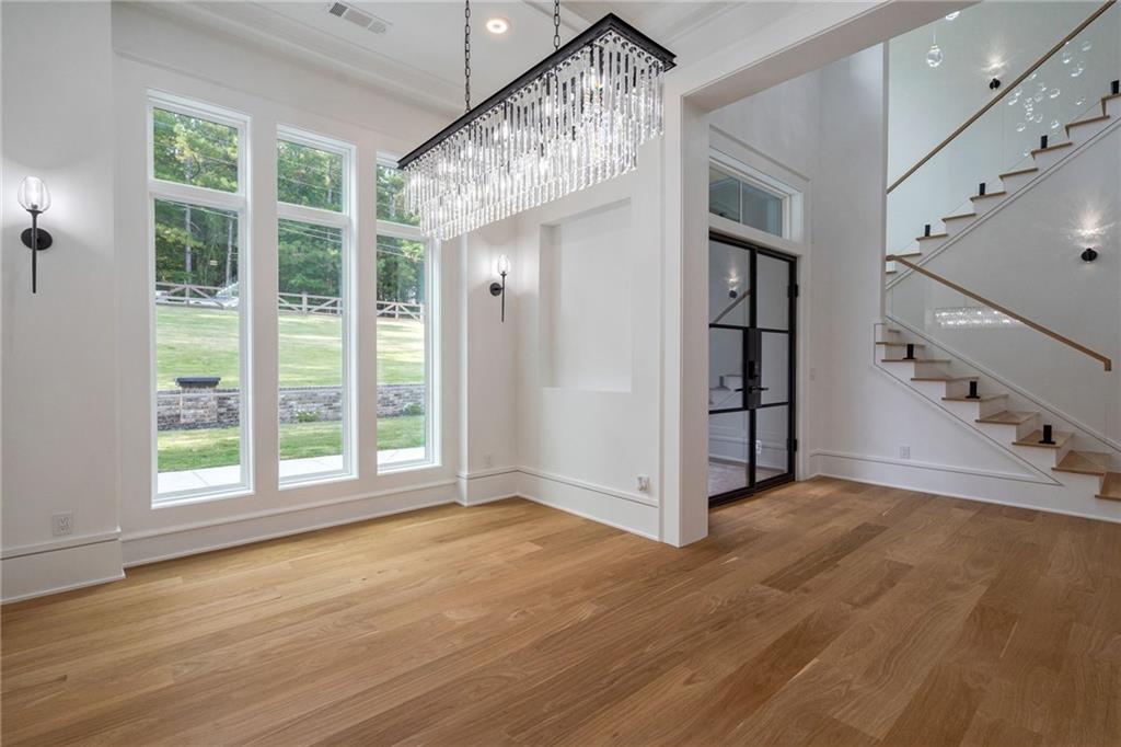 4459 Grady Smith Road Loganville, GA 30052 - Photo 38 of 124 a view of an empty room with a window and wooden floor