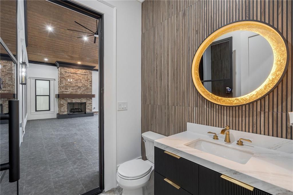 4459 Grady Smith Road Loganville, GA 30052 - Photo 48 of 124 a bathroom with a sink a toilet and a mirror