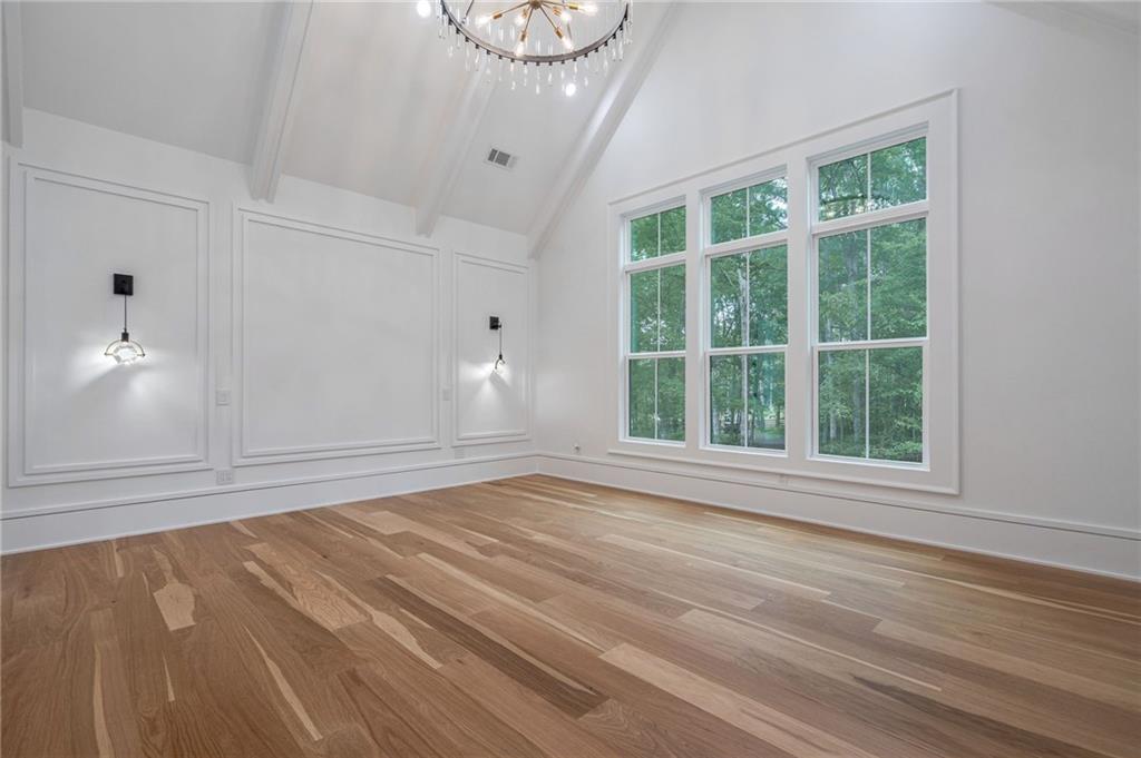 4459 Grady Smith Road Loganville, GA 30052 - Photo 5 of 124 a view of an empty room with wooden floor and a window