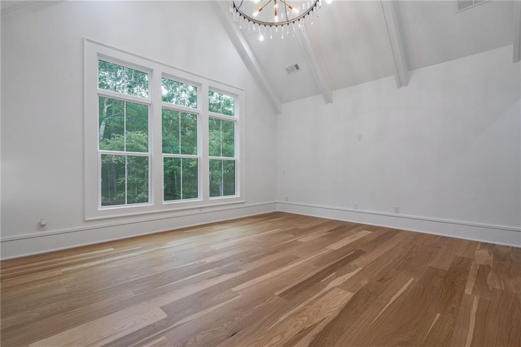 4459 Grady Smith Road Loganville, GA 30052 - Photo 53 of 124 a view of an empty room with wooden floor and a window